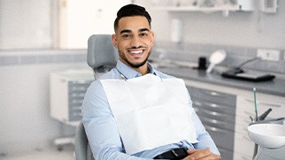 Patient smiling while sitting in treatment chair