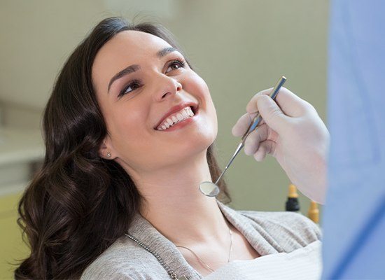 Woman in dental chair smiling