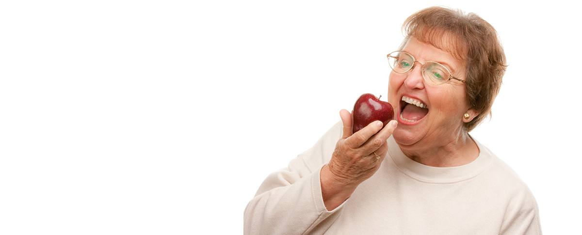 Older woman after full mouth replacement.