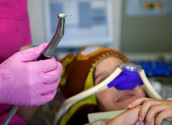 Child with nitrous oxide nose mask in place