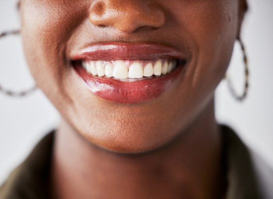 Closeup of woman with hoop earrings smiling