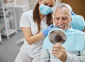 Man with cosmetic dentistry in Kingwood smiling in mirror