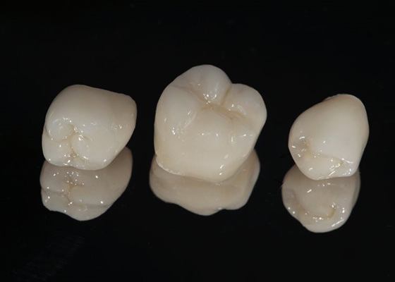 three dental crowns on black background