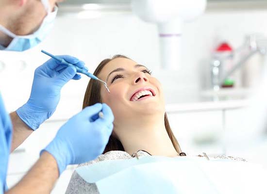 Woman smiling while visiting emergency dentist in Kingwood