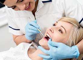 Woman visiting dentist for dental emergency in Kingwood
