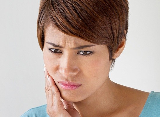 Woman holding jaw