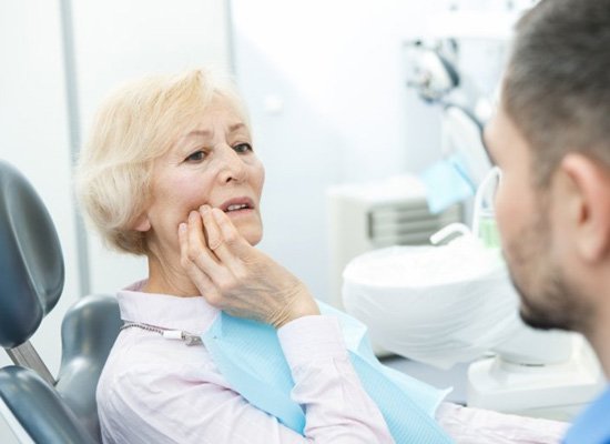 a patient visiting her dentist for dental implant salvage 