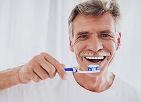 man brushing his teeth