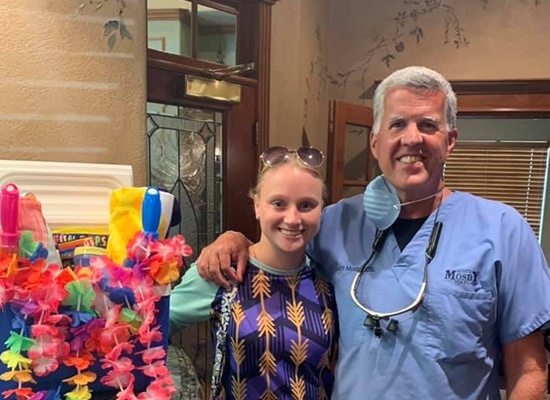 Dr. Mosby posing with dental patient