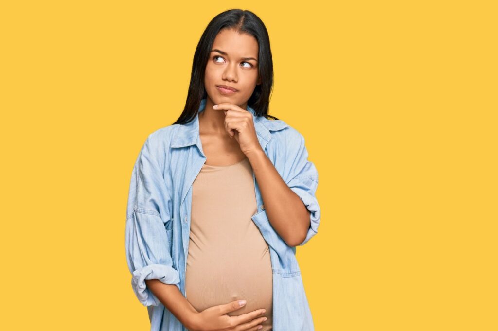 A pregnant woman pondering a question